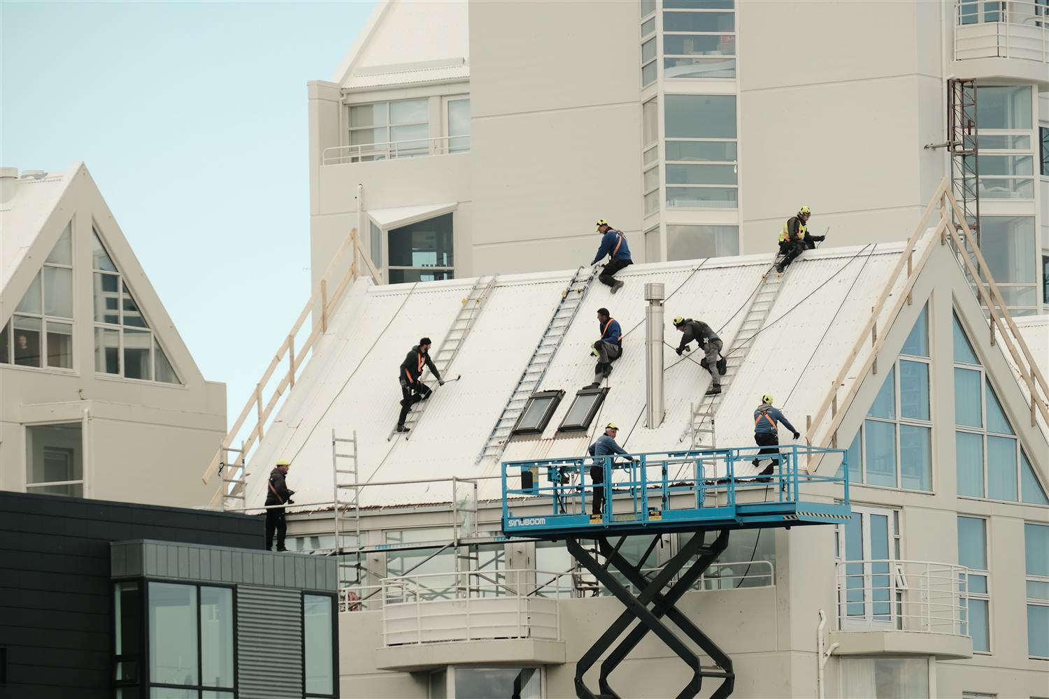 Roofing crew working on a large commercial building near Yulee