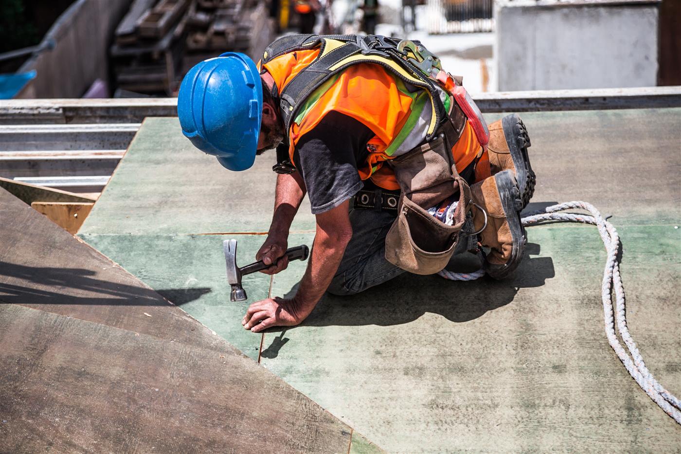 Roofing crew inspecting and repairing a coastal Atlantic Beach roof