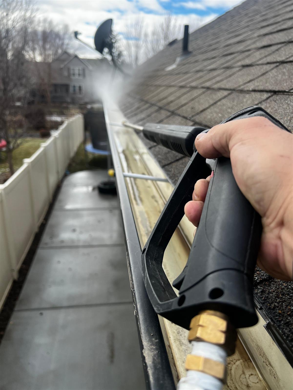 Roof Repair Jacksonville FL technician clearing and cleaning a clogged gutter