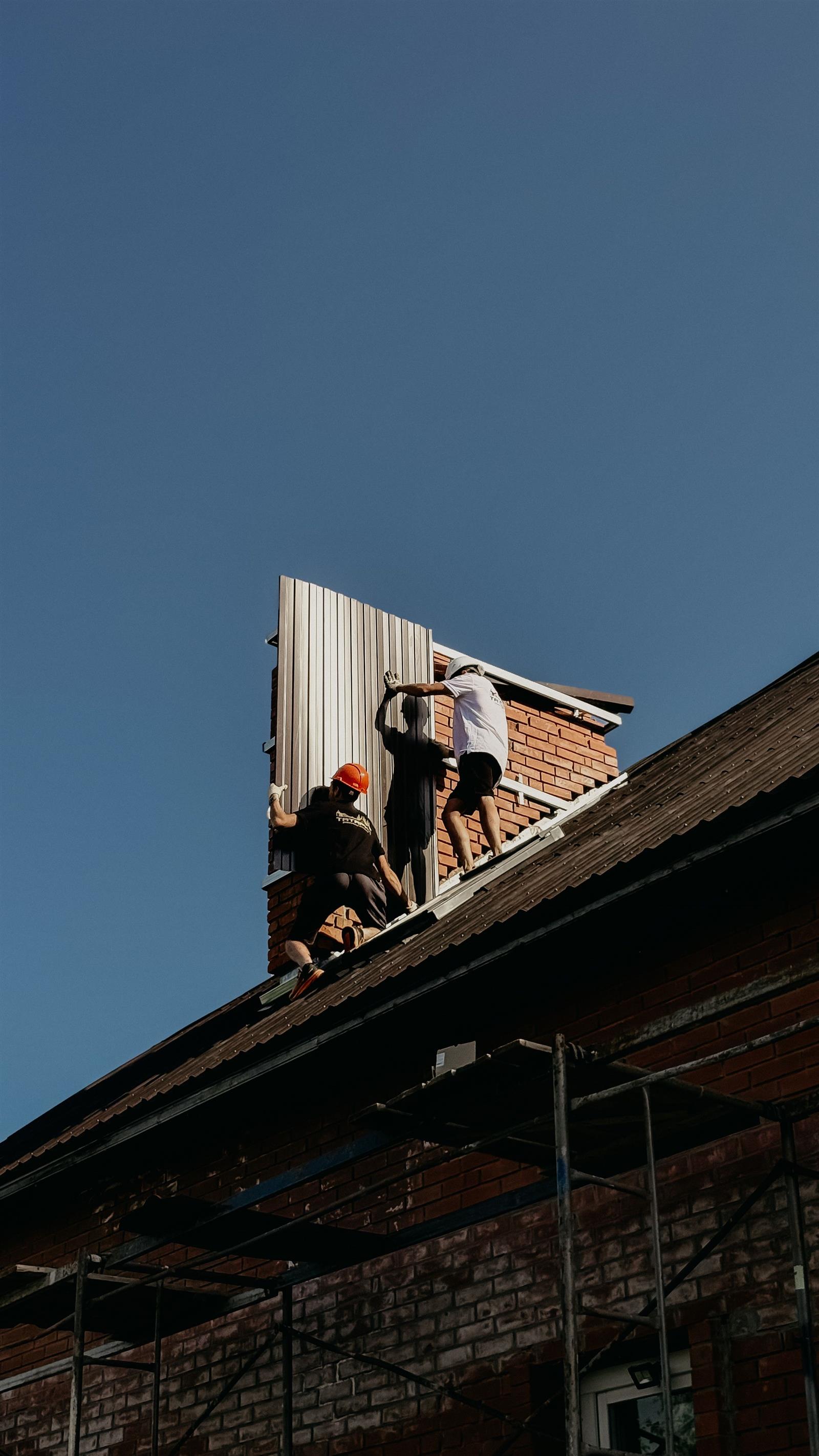 Roofer reinforcing flashing against coastal storm exposure in St Augustine